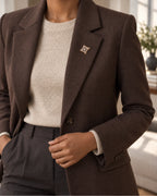 Dagny Pearl-Style Openwork Cross Brooch — model wearing the brooch with a tailored outfit, wider view
