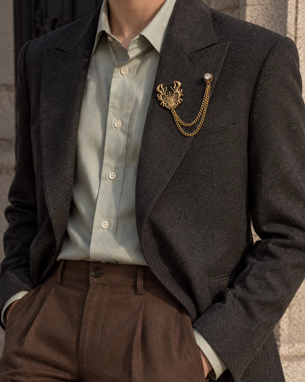 Draka Horned Crest Lapel Chain Brooch in gold-tone finish; wider faceless jacket styling