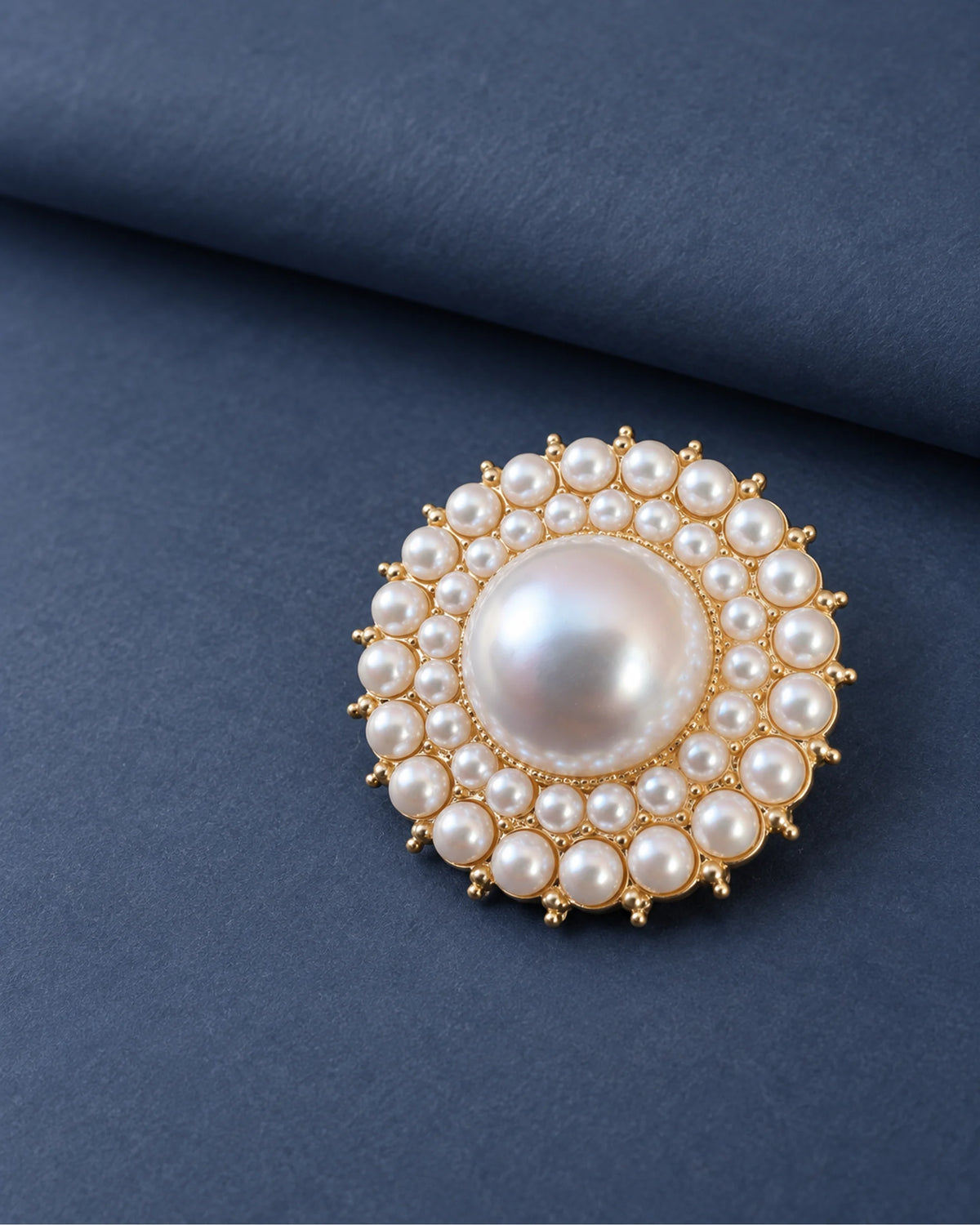 Elin Round Pearl-Style Cluster Brooch — front display on folded slate-blue paper