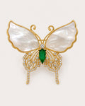 Elina Green Shell Butterfly Brooch on an exact #F0EBE9 background with directional light and a natural contact shadow.