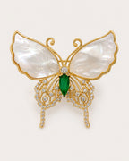 Elina Green Shell Butterfly Brooch on an exact #F0EBE9 background with directional light and a natural contact shadow.