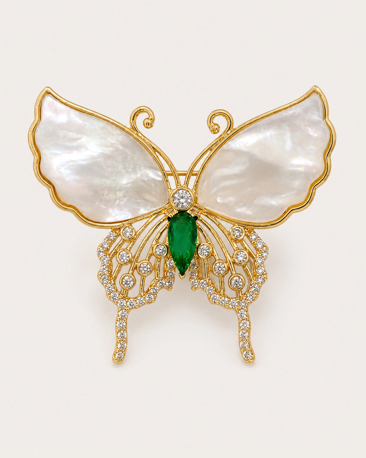 Elina Green Shell Butterfly Brooch on an exact #F0EBE9 background with directional light and a natural contact shadow.