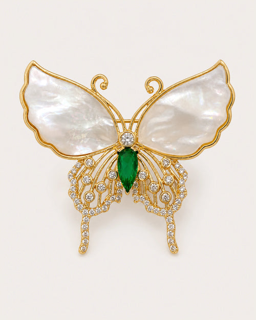Elina Green Shell Butterfly Brooch on an exact #F0EBE9 background with directional light and a natural contact shadow.