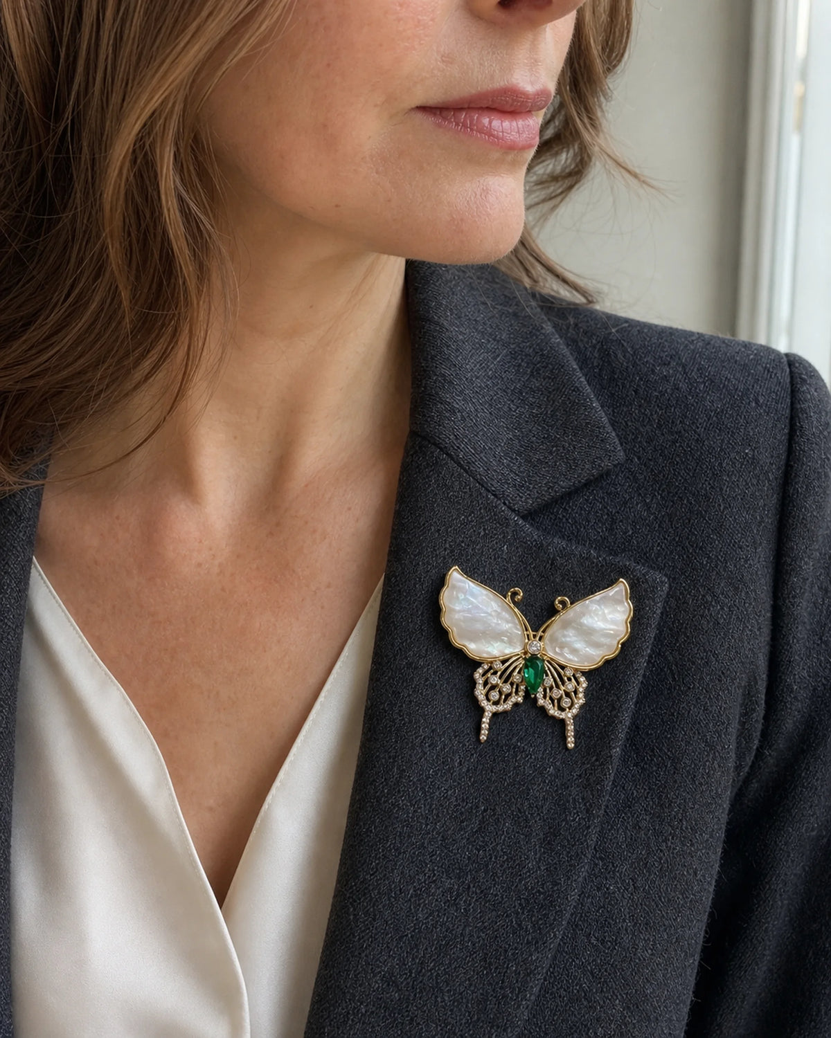 Close lapel view of the Elina Green Shell Butterfly Brooch worn at its natural 4.2 cm width.