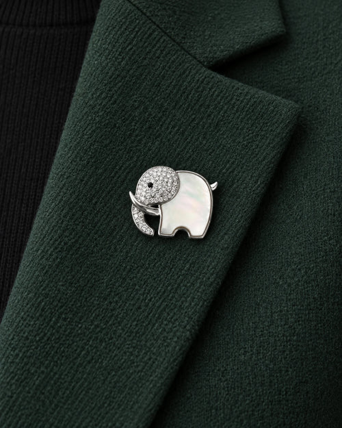 Elli Shell Elephant Magnetic Brooch, Silver & White worn on a green jacket lapel, close view