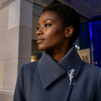 Silver and sapphire blue Elowen Crystal Spray Brooch worn at true 6.2 cm scale on a slate blue coat