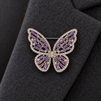 The Silver & Purple butterfly sits within one broad charcoal wool lapel.
