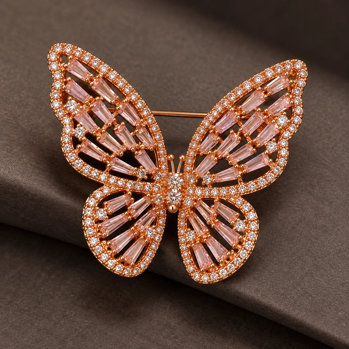 The Rose Gold & Pink finish reveals tapered baguettes, small clear edge stones and the spaces between wing ribs.