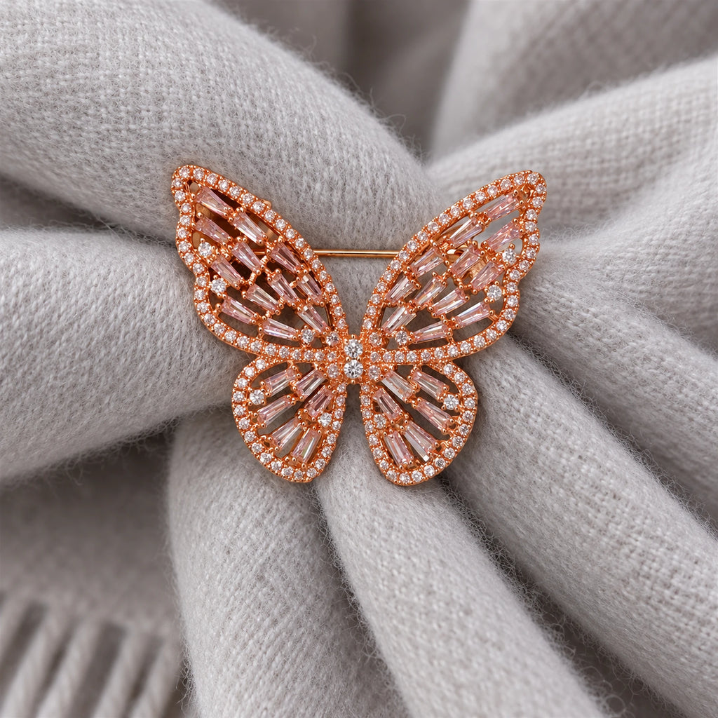Doubled pale-gray wool scarf folds support the Rose Gold & Pink butterfly.