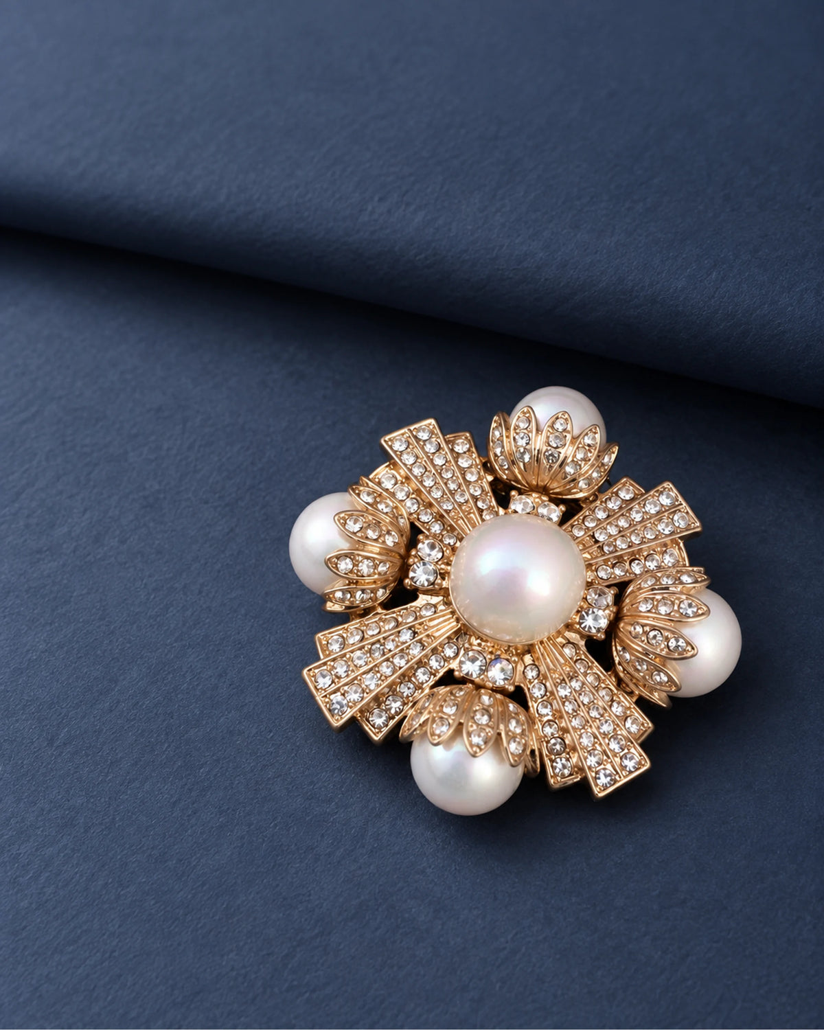 Estrid Pearl-Style Star Cross Brooch — front display on folded slate-blue paper