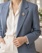 Estrid Pearl-Style Star Cross Brooch — model wearing the brooch with a tailored outfit, wider view