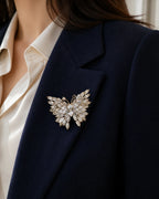 Close view of the 5.0 by 4.0 centimetre Eveli Butterfly Brooch pinned fully to the folded lapel of a navy blazer