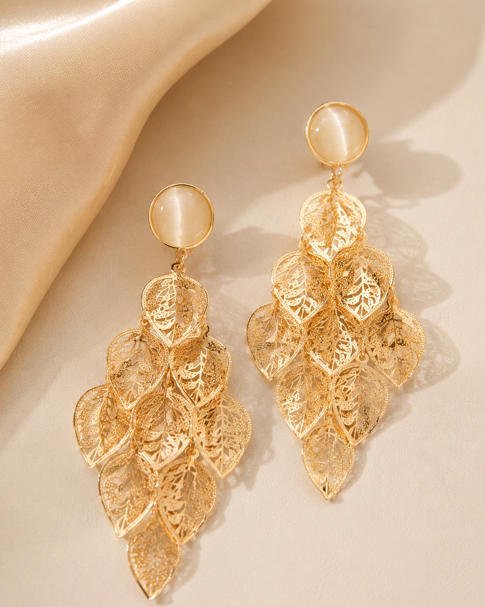 Close view of Lehti Gold Leaf Earrings with sculptural cascading leaves