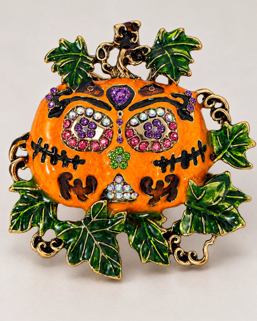 The Ornate Pumpkin combines a jeweled face with orange surfaces and a green leafy border.