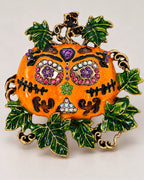 The Ornate Pumpkin combines a jeweled face with orange surfaces and a green leafy border.