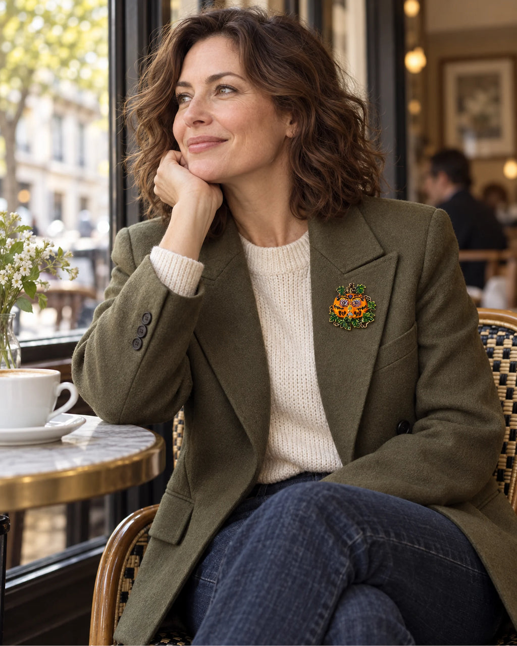 The Ornate Pumpkin adds a small bright face to an olive jacket and cream knit.