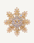 Halla Eight-Point Crystal Snowflake Brooch on a warm #F0EBE9 studio background with a natural contact shadow