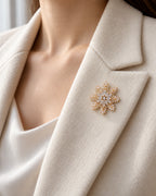 Halla crystal snowflake brooch, gold tone — close lapel styling