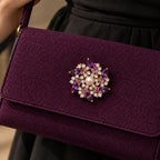 A reinforced plum fabric bag flap supports all six purple points and the pearl centre.