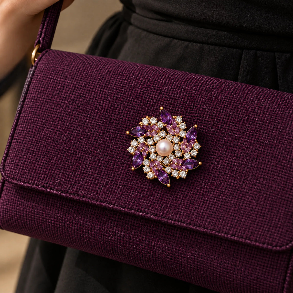 A reinforced plum fabric bag flap supports all six purple points and the pearl centre.