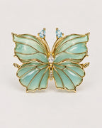 Ilma blue-green translucent enamel butterfly brooch with gold-tone wing veins, front view