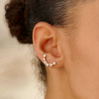 Side view of Ilo Smile Pave Stud Earrings worn on ear