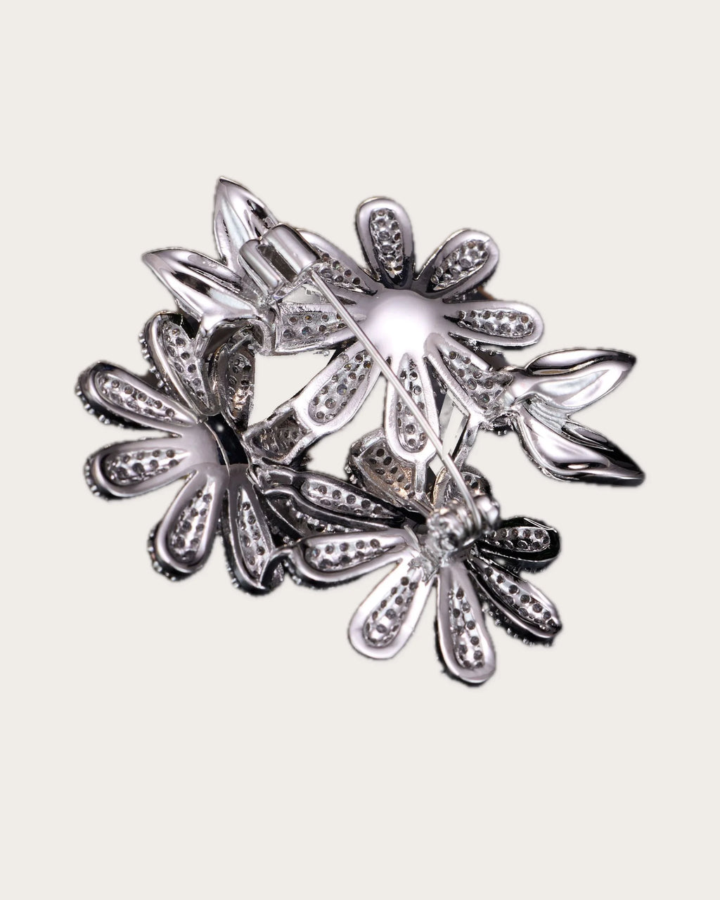 Back construction view of the Ilona brass daisy brooch showing the hinged pin and catch