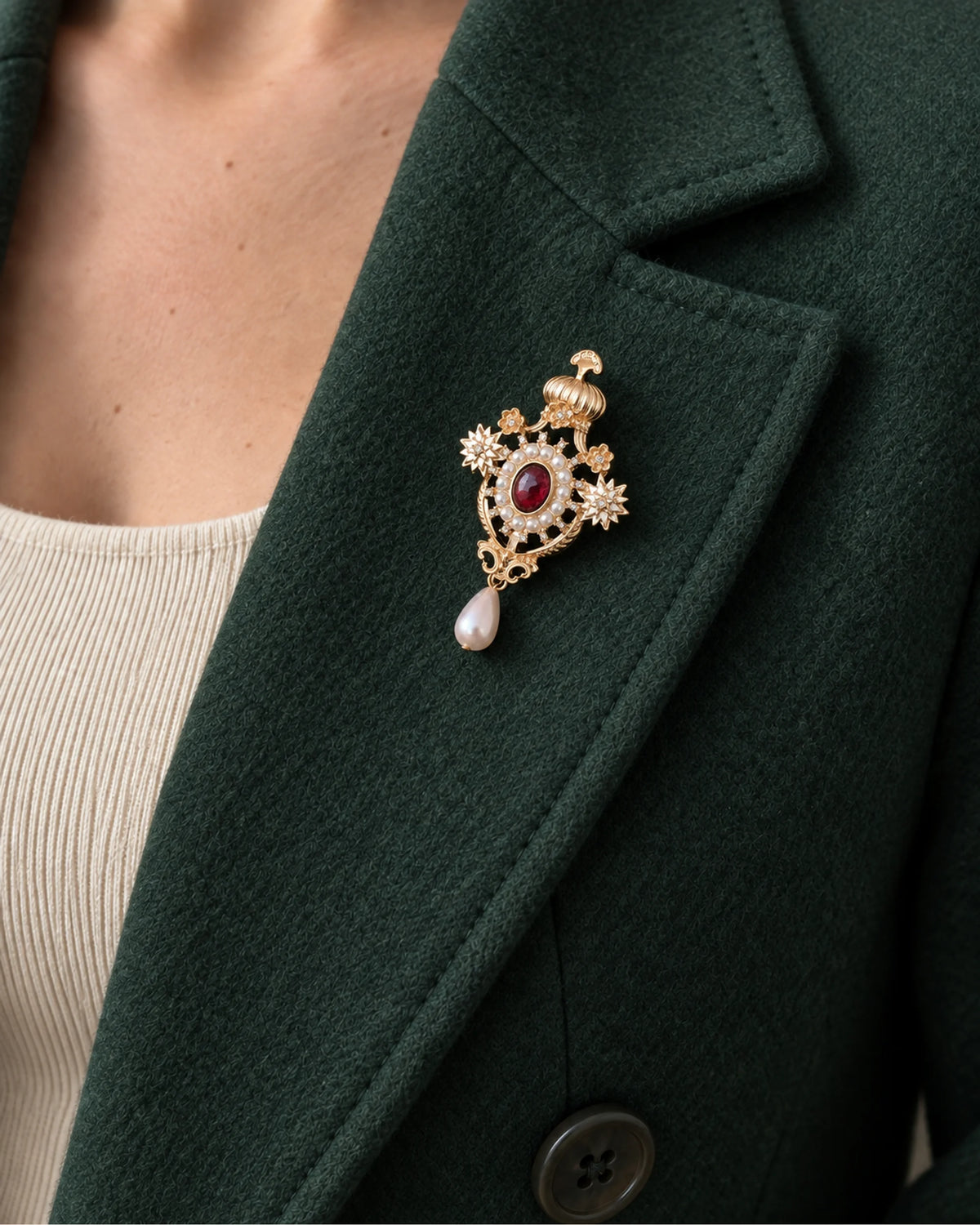Ingrid Red Crown Drop Brooch — model wearing the brooch on a jacket lapel, close view