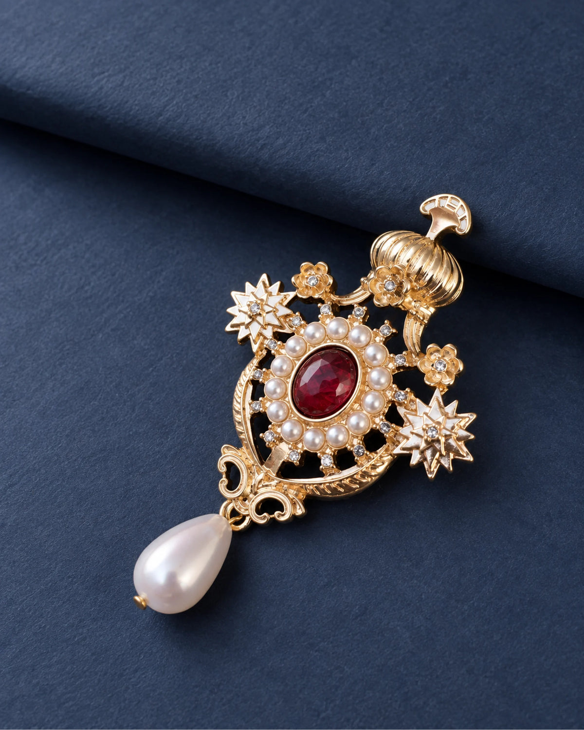 Ingrid Red Crown Drop Brooch — front display on folded slate-blue paper