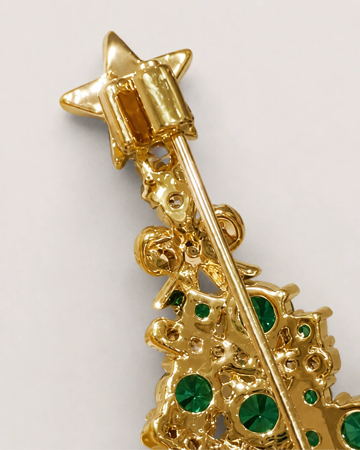 Cropped rear view showing the upper hinge and long pin behind the Christmas tree.