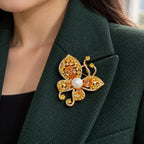 The champagne butterfly is supported within a deep-green folded lapel.