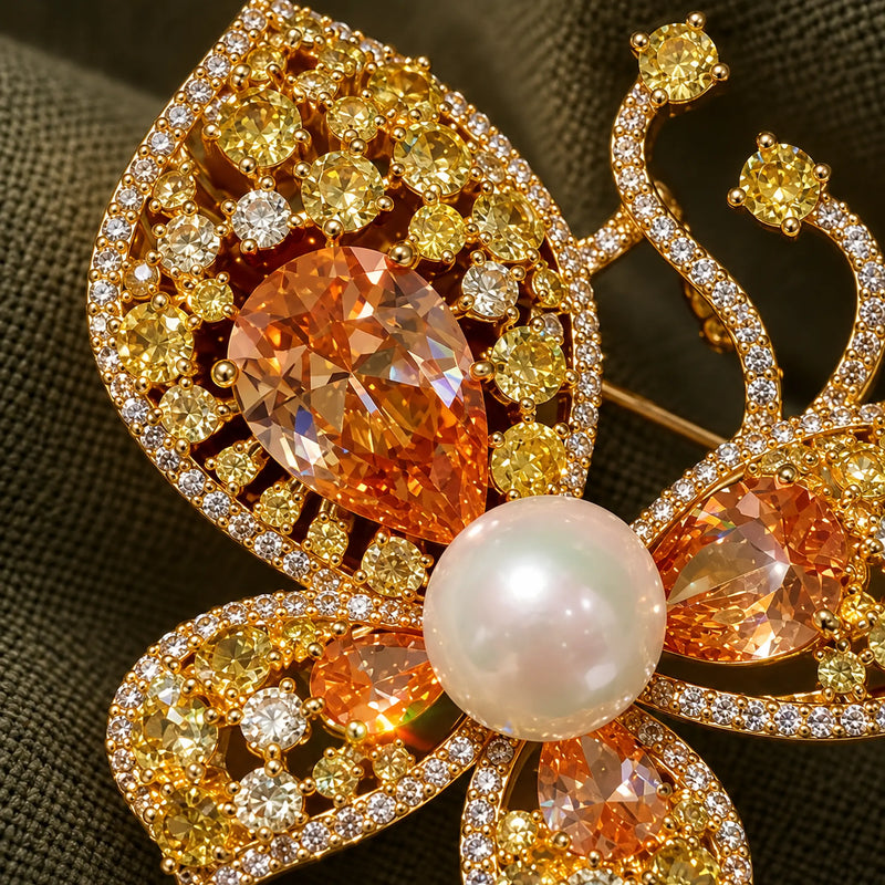 Champagne zircon and a pearl-look centre rise above the gold-plated openwork.