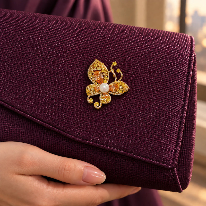 A reinforced plum fabric flap supports the small butterfly as a bag accent.