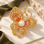 Complete Kaisa Champagne Zircon Butterfly Brooch resting on ivory paper beside silk and pale limestone.