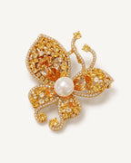 Kaisa Champagne Zircon Butterfly Brooch shown complete on a warm plain background.