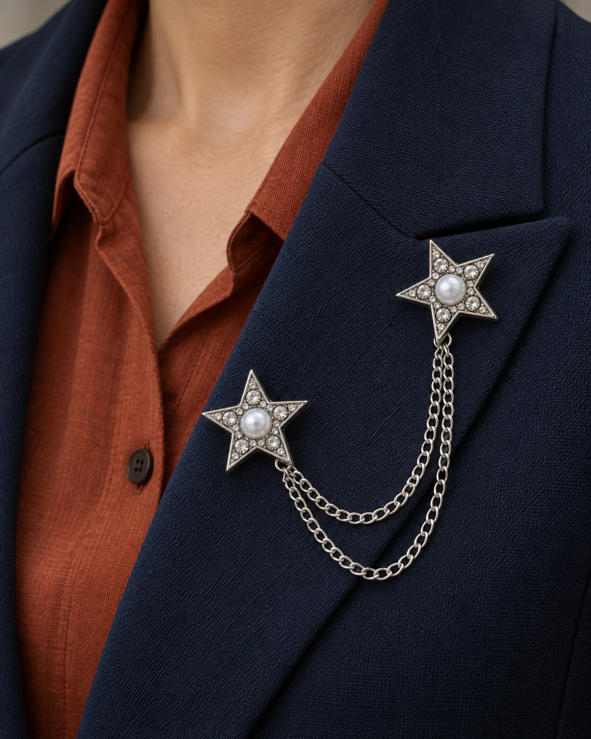 Kaksi Twin Star Lapel Chain Brooch in silver-tone finish; close wearing view on a structured lapel