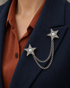 Kaksi Twin Star Lapel Chain Brooch in silver-tone finish; close wearing view on a structured lapel