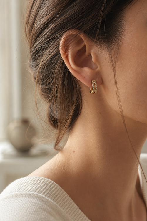 Kide Crystal Huggie Earrings worn in soft window light