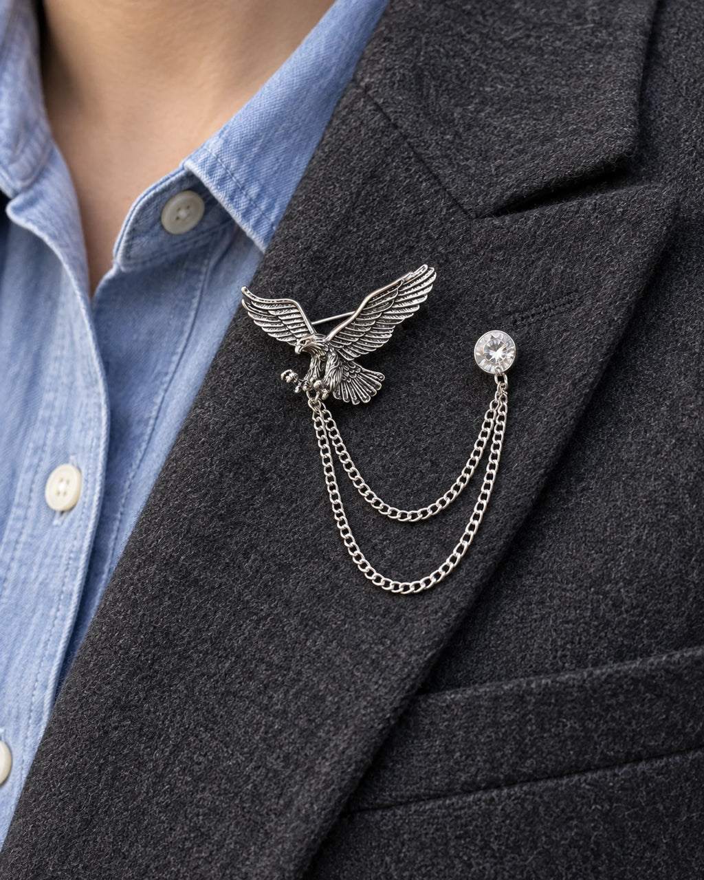 Kotka Eagle Lapel Chain Brooch in silver-tone finish; close wearing view on a structured lapel