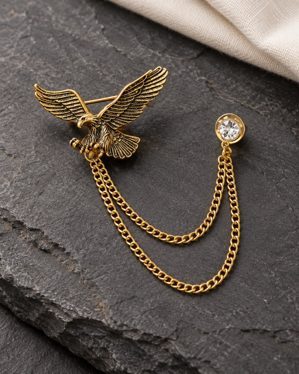 Kotka Eagle Lapel Chain Brooch in gold-tone finish; complete still-life drape