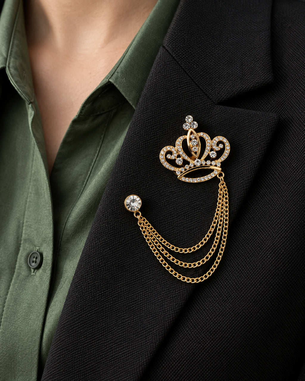Kruunu Openwork Crown Lapel Chain Brooch in gold-tone finish; close wearing view on a structured lapel