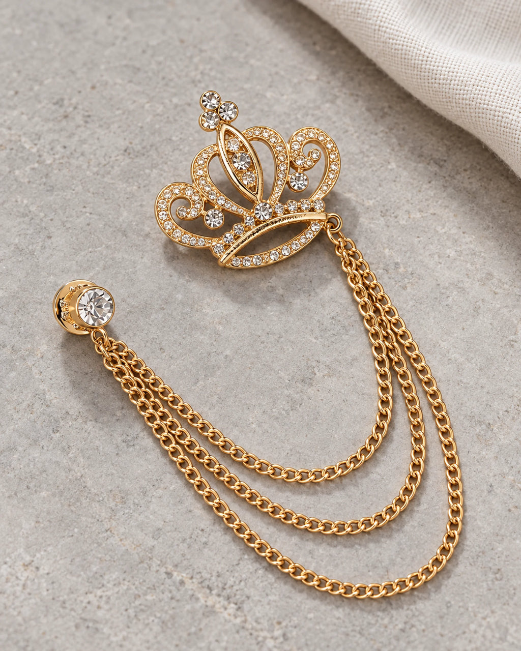 Kruunu Openwork Crown Lapel Chain Brooch in gold-tone finish; complete still-life drape