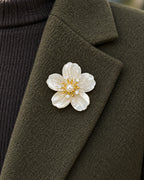 Kukka Shell Blossom Magnetic Brooch, Gold & White worn on a olive jacket lapel, close view
