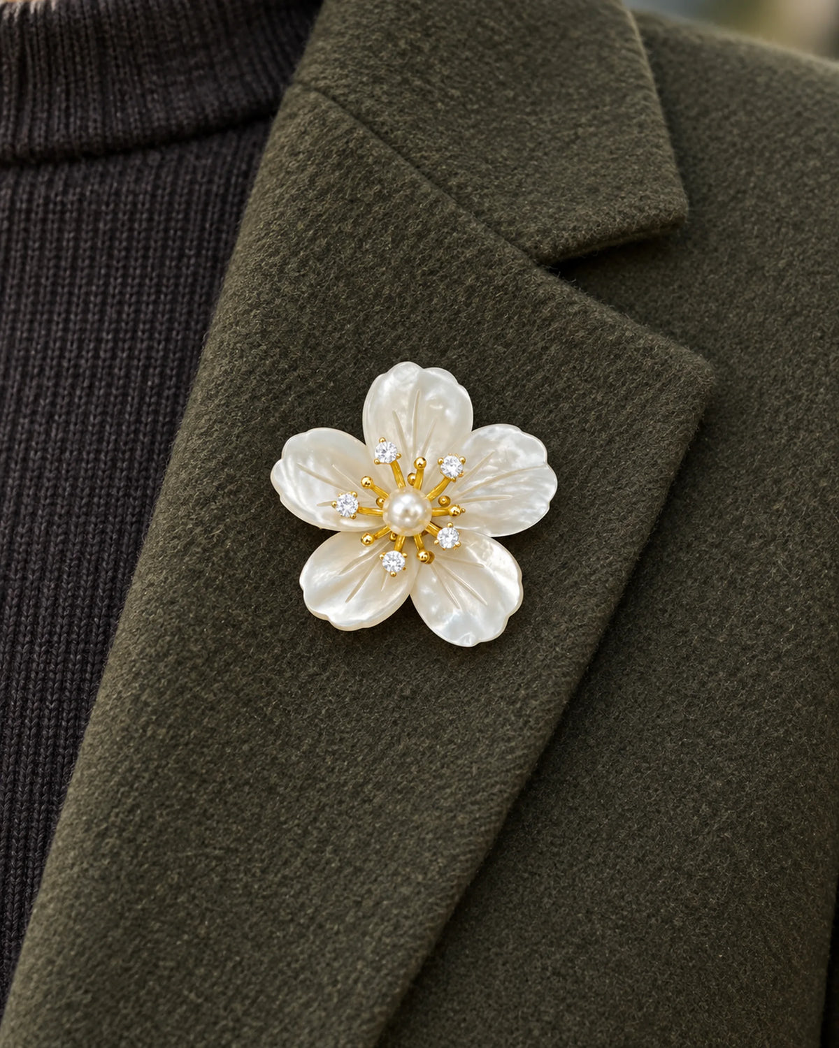 Kukka Shell Blossom Magnetic Brooch, Gold & White worn on a olive jacket lapel, close view