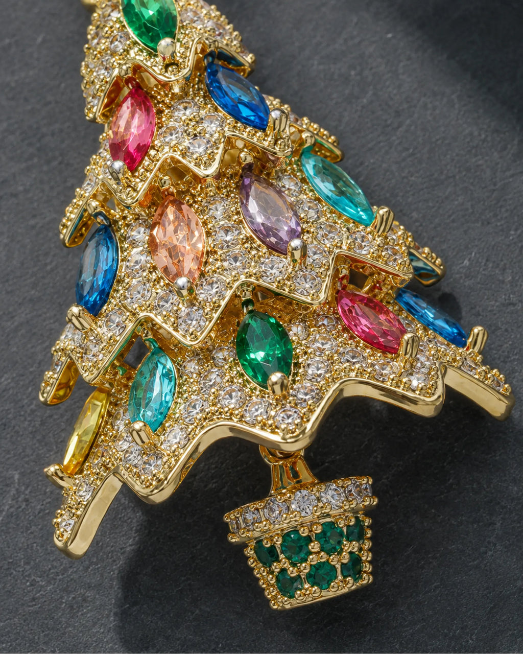 Detail of colored marquise stones, gold-tone branches and the Kuusi green-stone pot.