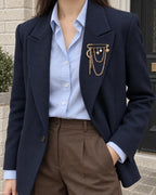 Kuutar Moon and Star Safety Pin Brooch in gold-tone finish — wider wearing view with neutral tailoring