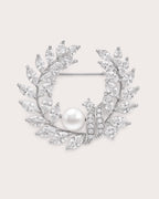 Laurea silver freshwater pearl leaf wreath brooch with clear stones and visible horizontal pin.