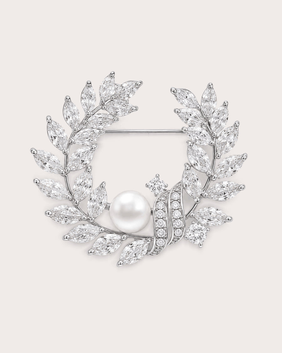Laurea silver freshwater pearl leaf wreath brooch with clear stones and visible horizontal pin.