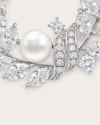Laurea close detail of the freshwater pearl and curved stone-set ribbons on the silver wreath brooch.