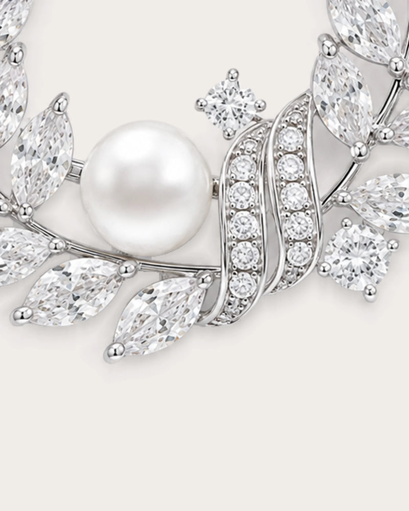 Laurea close detail of the freshwater pearl and curved stone-set ribbons on the silver wreath brooch.